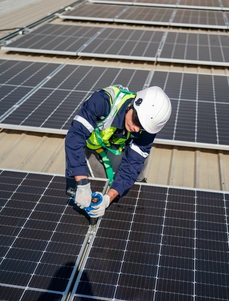 Solar installer on roof in Sydney